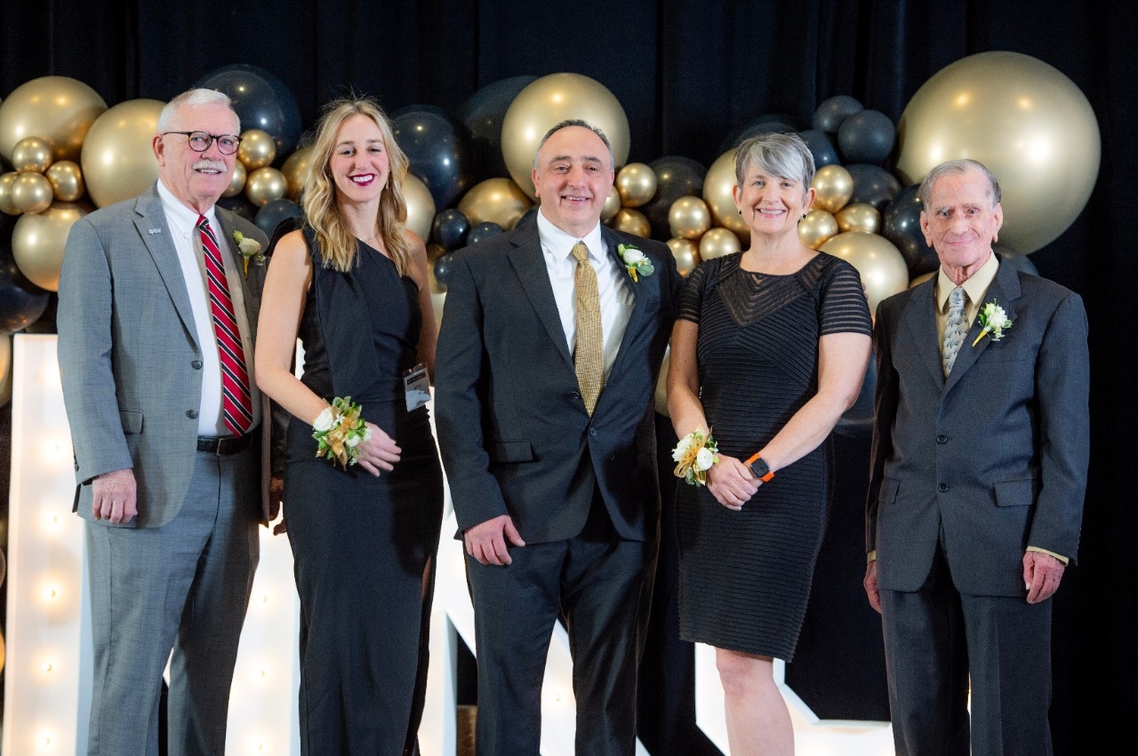 Group of people in business attire at the Alumni Awards