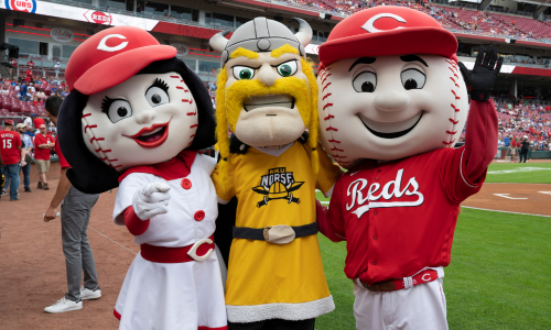 Victor E. Viking standing with Mr. Red and Rosie Redlegs at Great American Ballbark