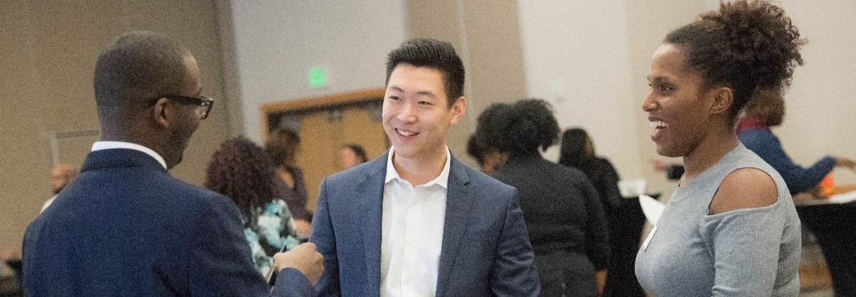 Employer smiling while talking to a student in an interview