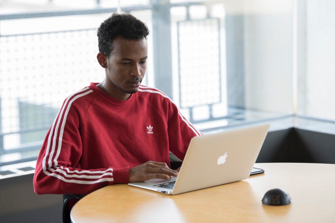 Male student on Mac computer