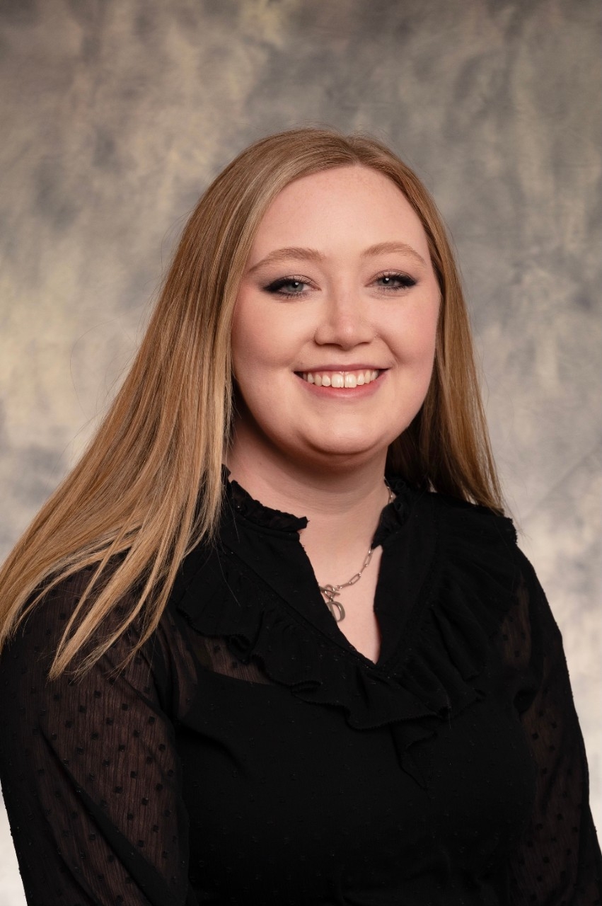 A professional headshot taken of Devan Murphy