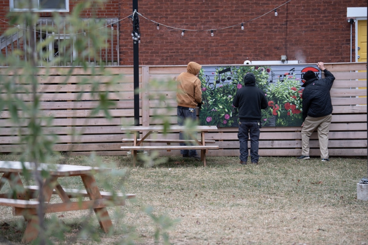 Volunteers installing a mural in Newport, KY