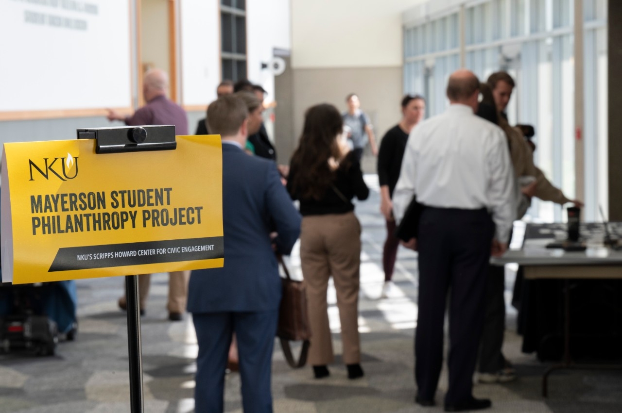 Mural depicting woman reading to students.
