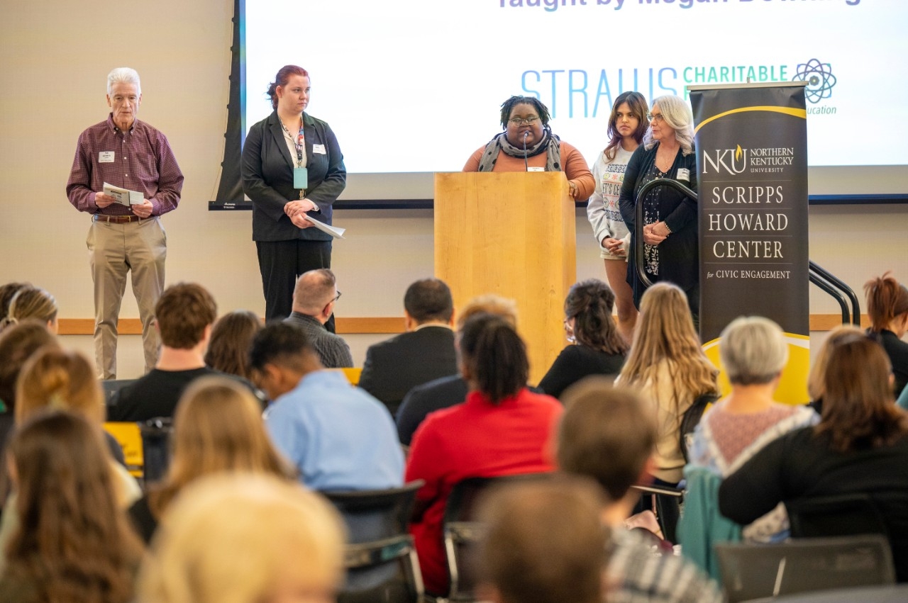 Line of volunteers working outdoors on excavation project.