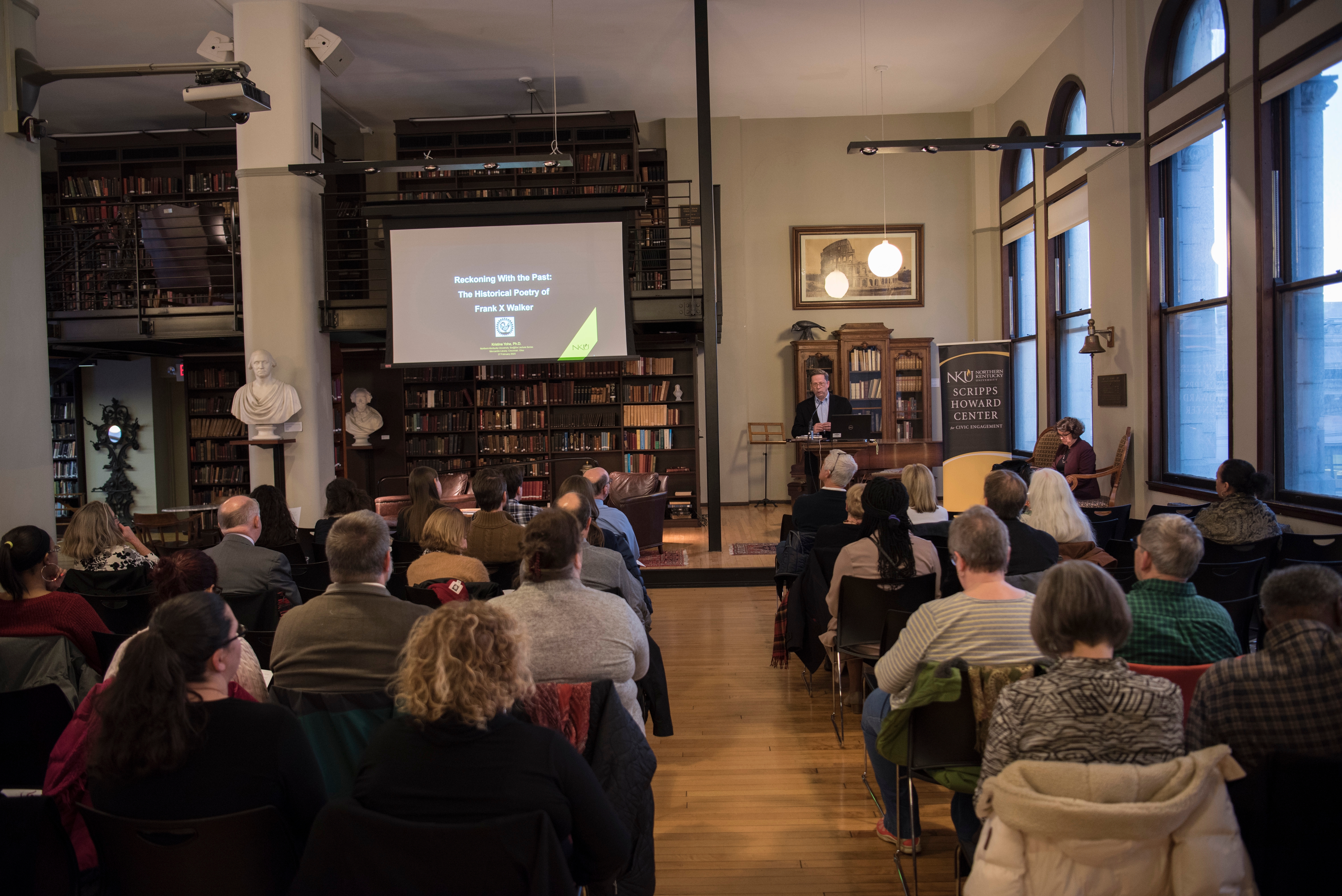 Kristine Yohe speaking in front of a group at the Mercantile Library