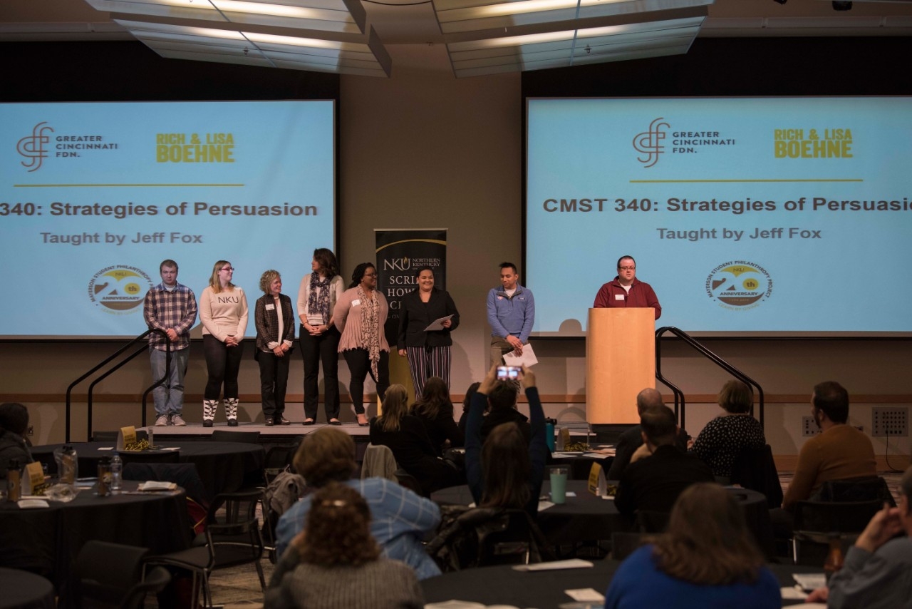 Group of students giving a "strategies of persuasion" presentation