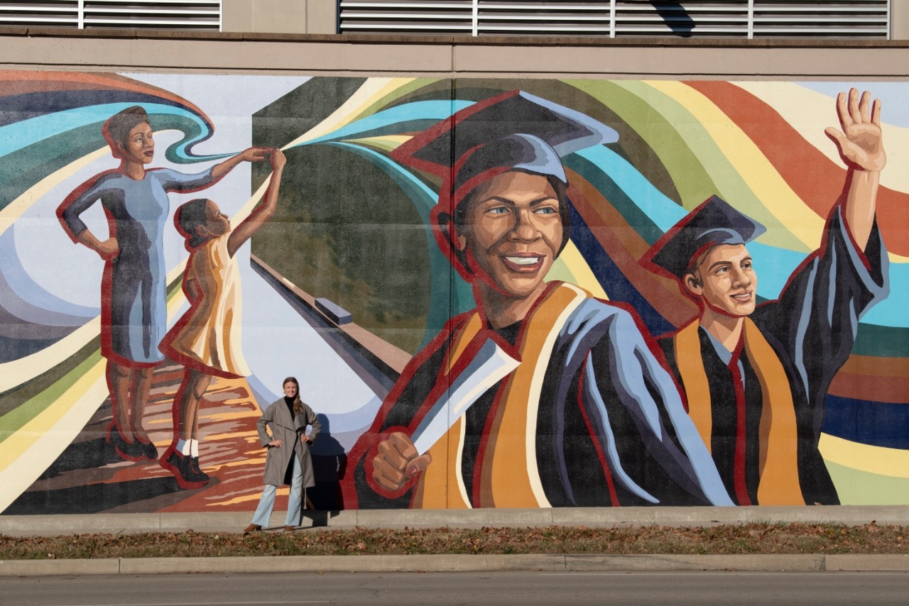 A mural depicting graduates