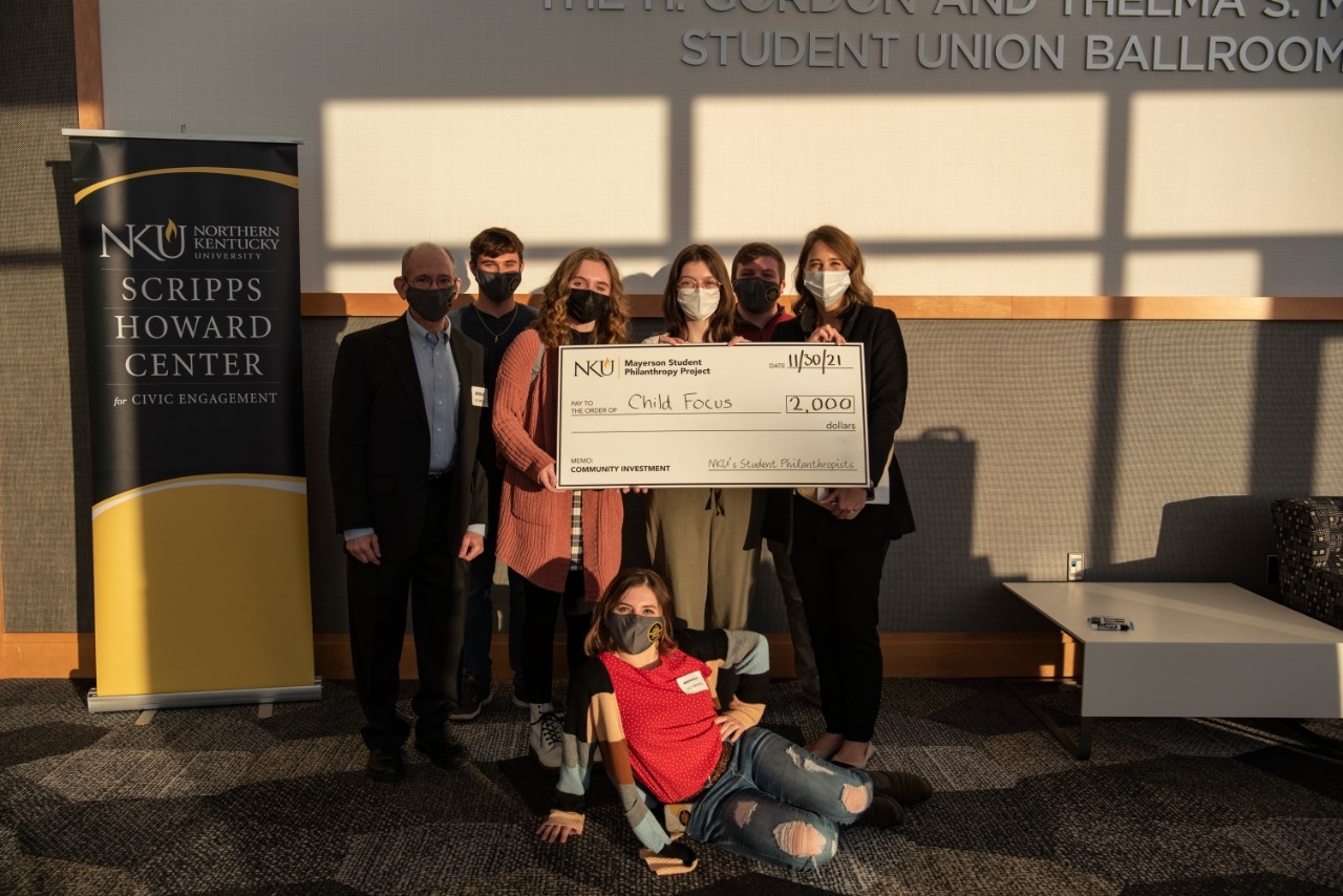 People posing with large donors check.