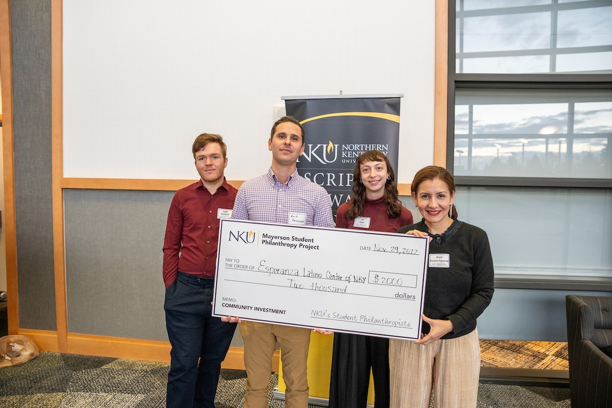 Participants pose with a presentation check.