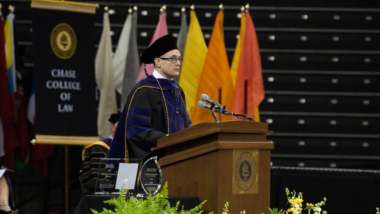 Speaker giving remarks at the Chase Law commencement ceremony.