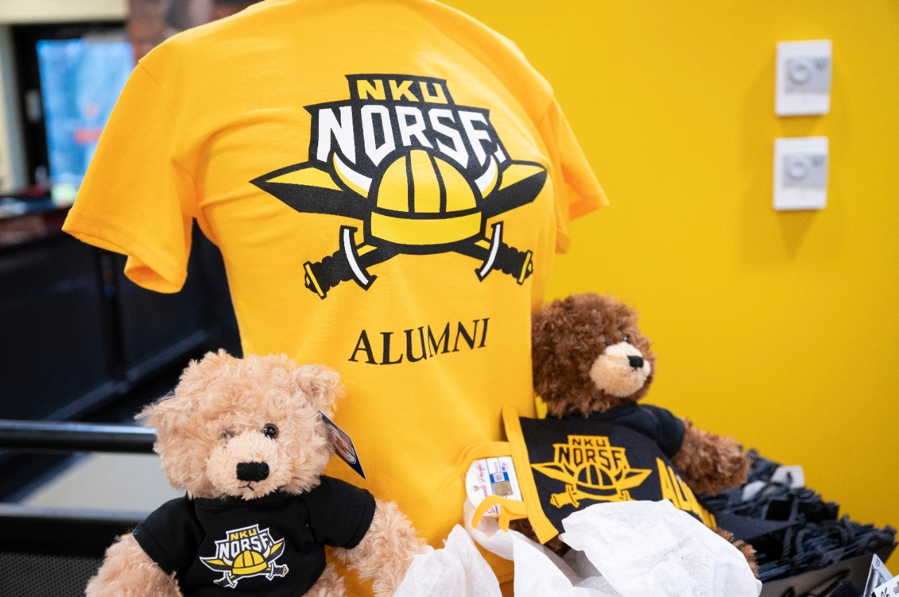 Image of NKU Alumni T-Shirt and two teddy bears wearing NKU shirts on display.