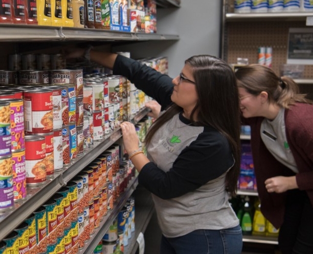 Students stocking shelves with non-perishables