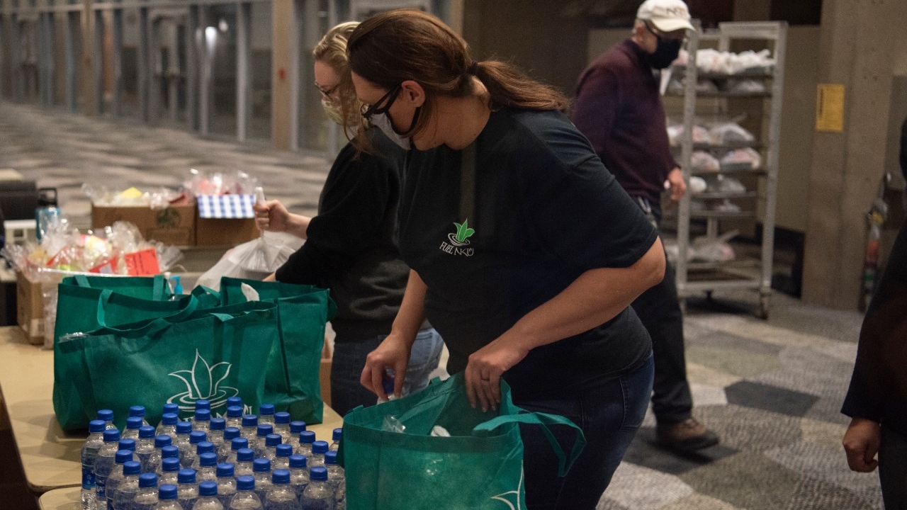 FUEL NKU workers provide bottles of water and other items to students