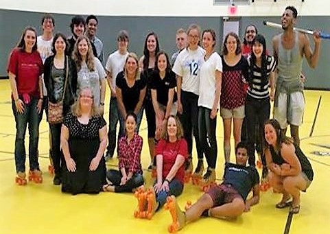 Group of students sitting inside gym