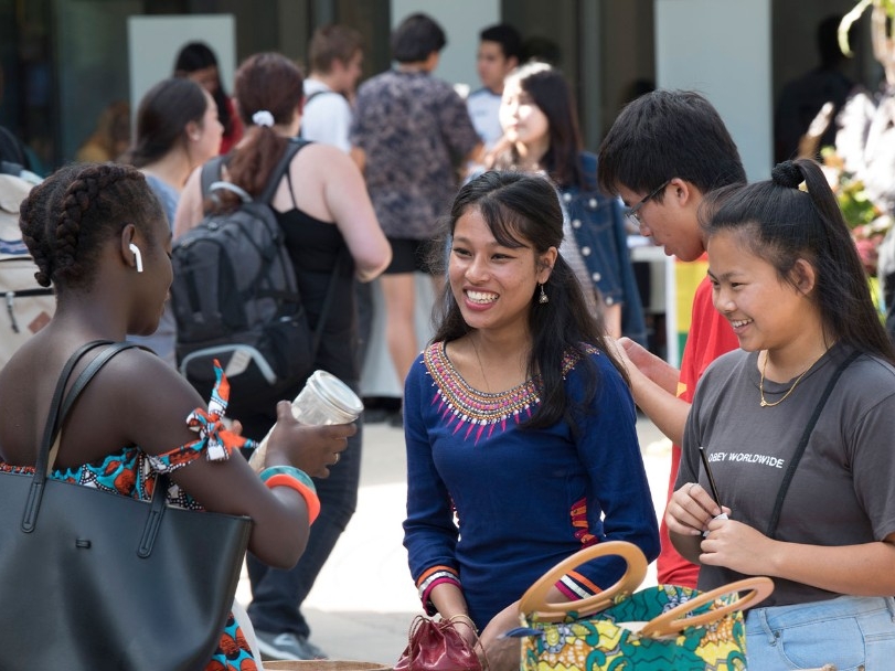Group of international students talking outside on NKU's campus.