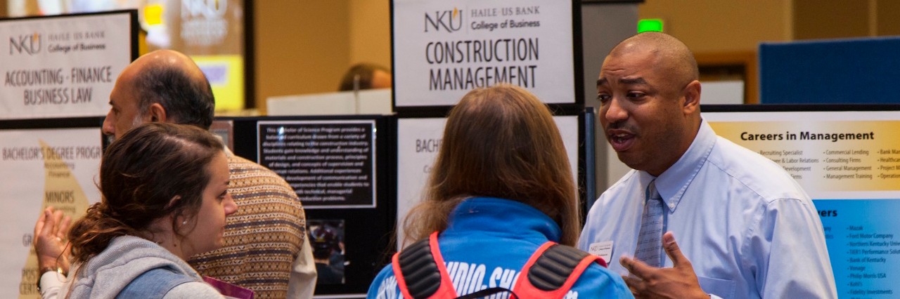 Two students learning about an academic program at major minor fair.