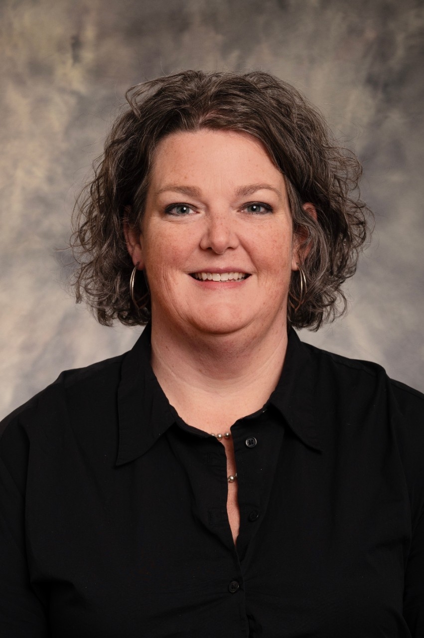 Photo of a dark curly haired middle aged woman