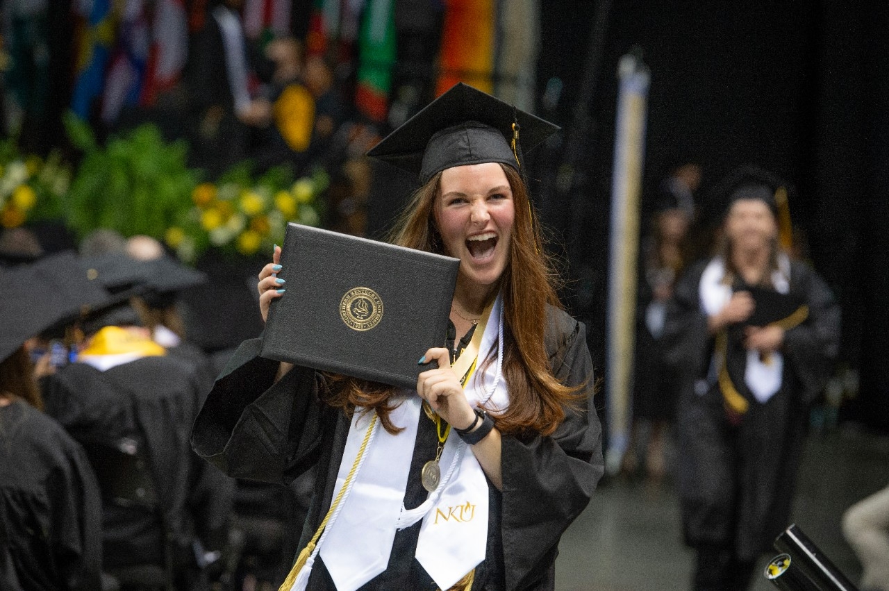 Student holding up her diploma