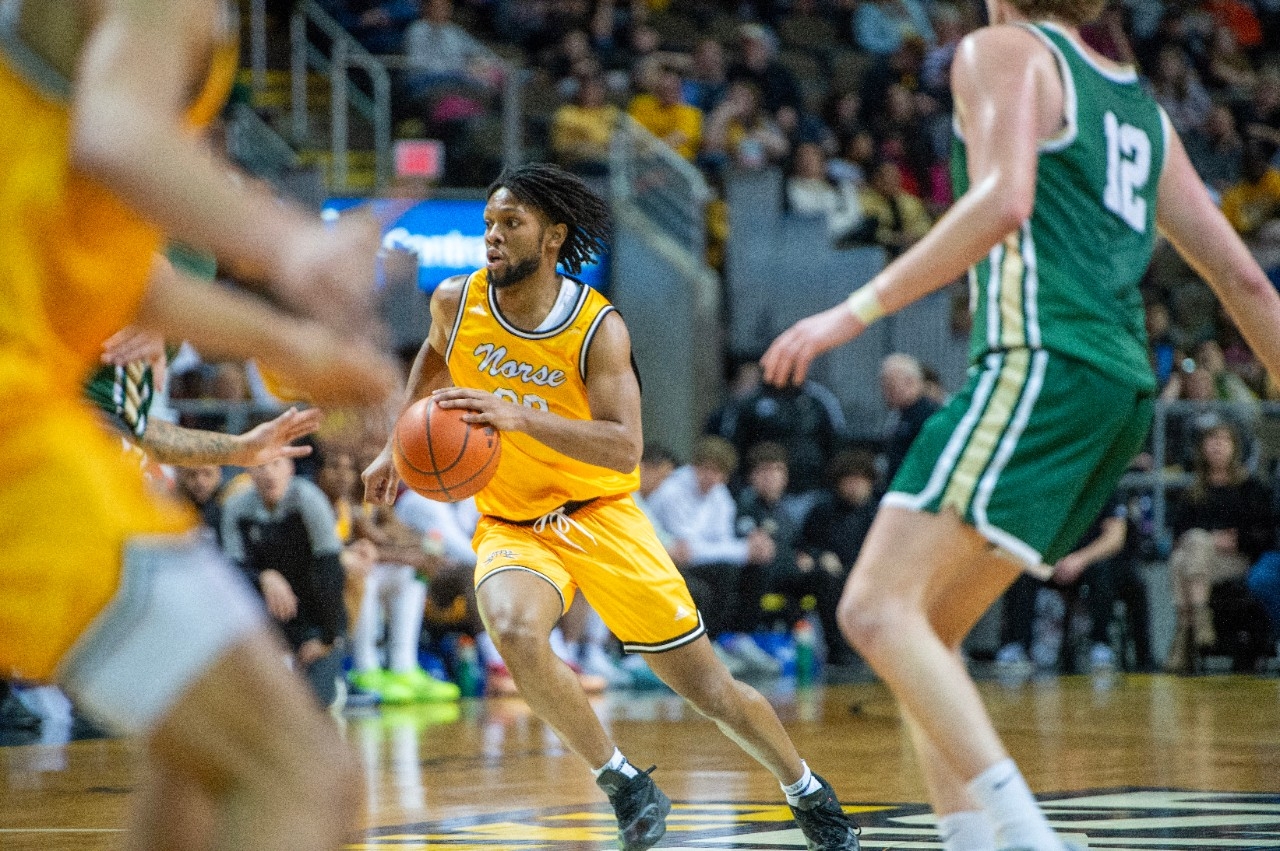 NKU mens basketball player rushing forward on the court
