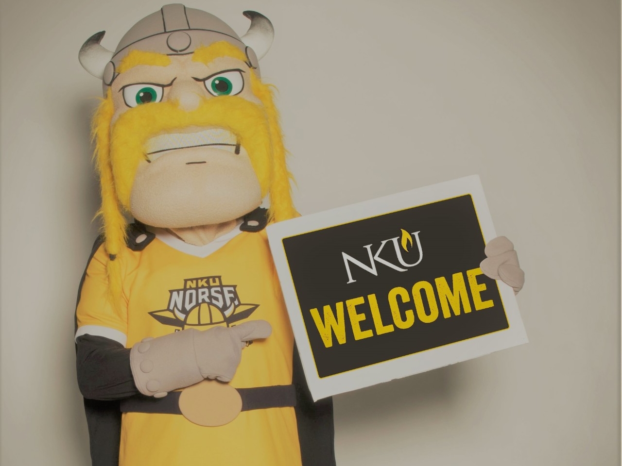 Victor E. Viking holding Welcome sign