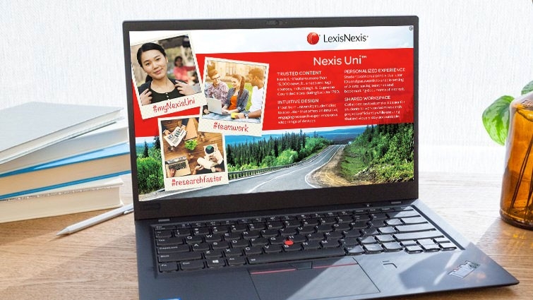 Laptop with Nexis Uni website on the screen and books behind computer.