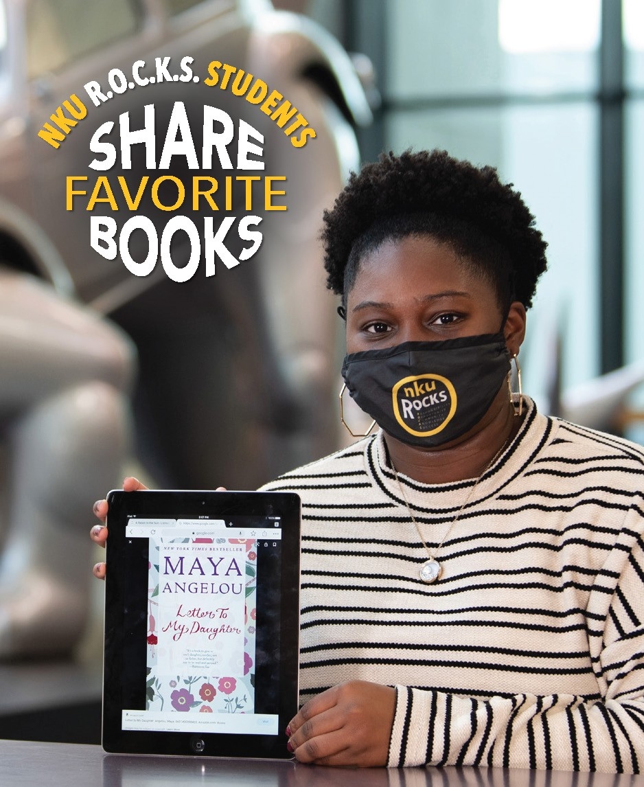 Alyca White poses with her book, “Letter to my Daughter” by Maya Angelou