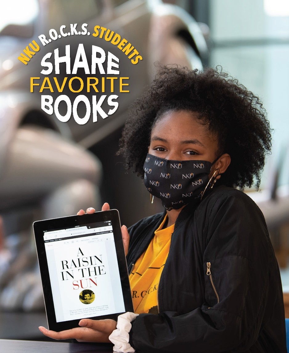 Briocca Green poses with book, “A Raisin in the Sun” by Lorraine Hansberry
