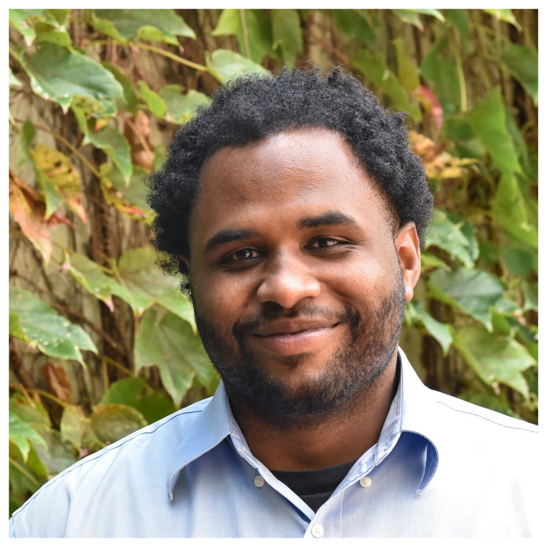 Headshot of Parnell Talley JR in front of green vines