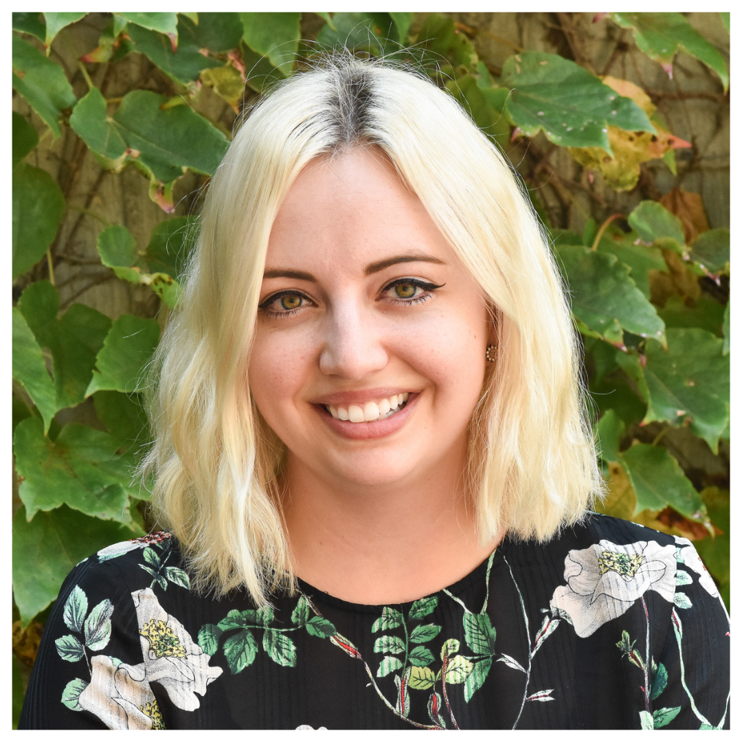 Headshot of Brianna Marshall in front of green vines
