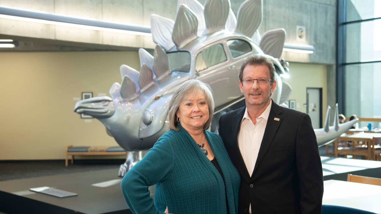 Greg and Sheila Edwards in front of Stego in Steely Library