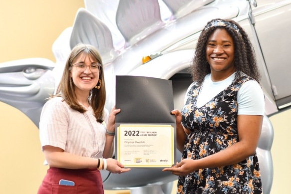 Onyinye Uwolloh and Hailley Fargo pose with the Steely Research Award certificate.