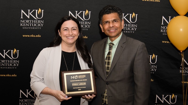 Dean Falcone accepts Excellence in Access Award on behalf of Steely Library from NKU President Ashish Vaidya