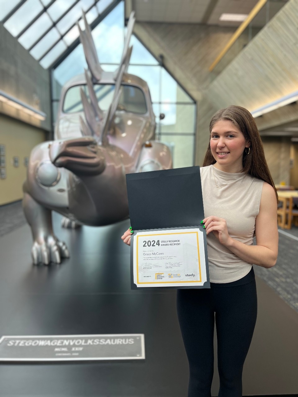 Grace McConn – poses with the Steely Research Award certificate.