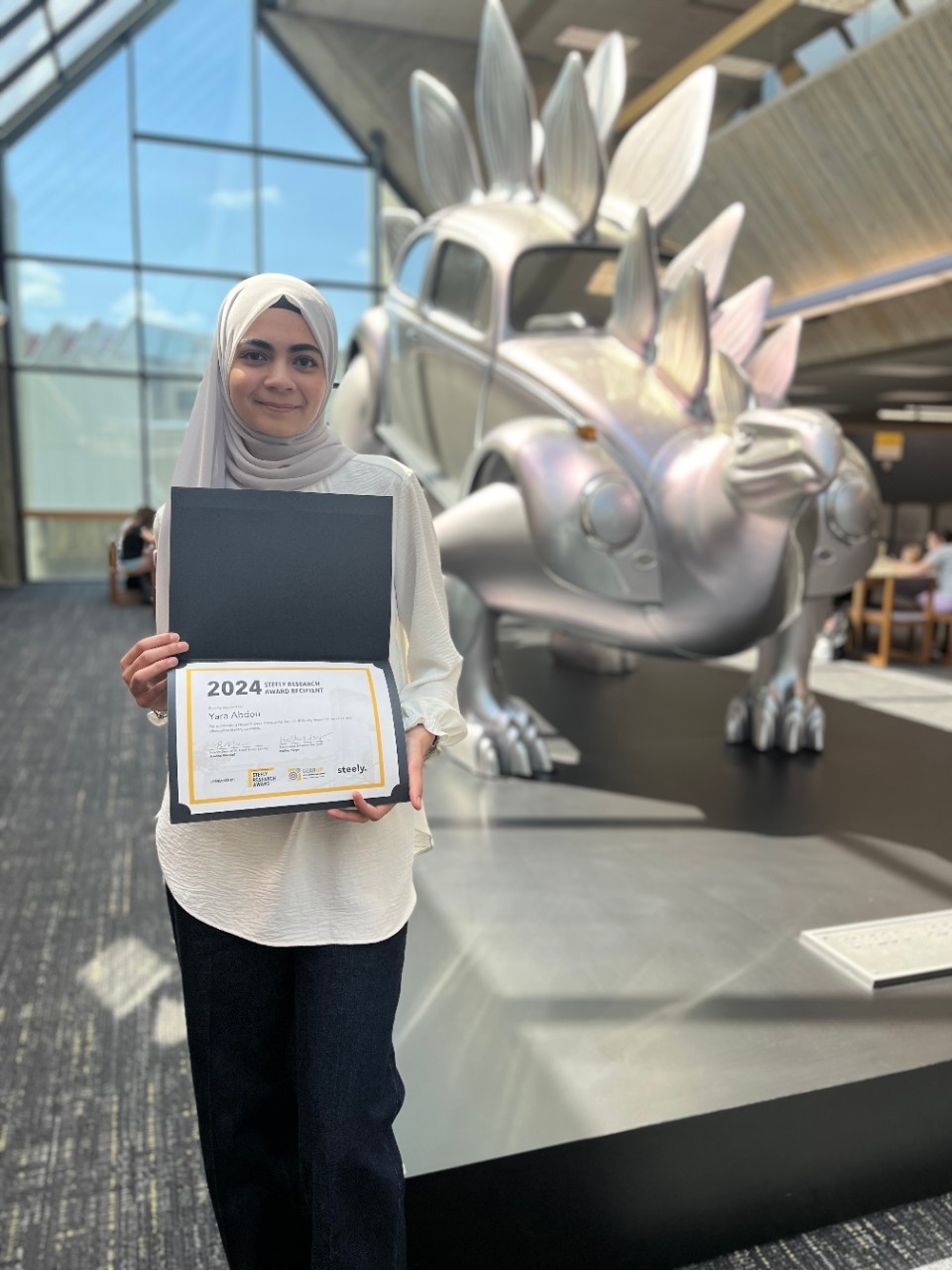 Yara Abdou poses with the Steely Research Award certificate.
