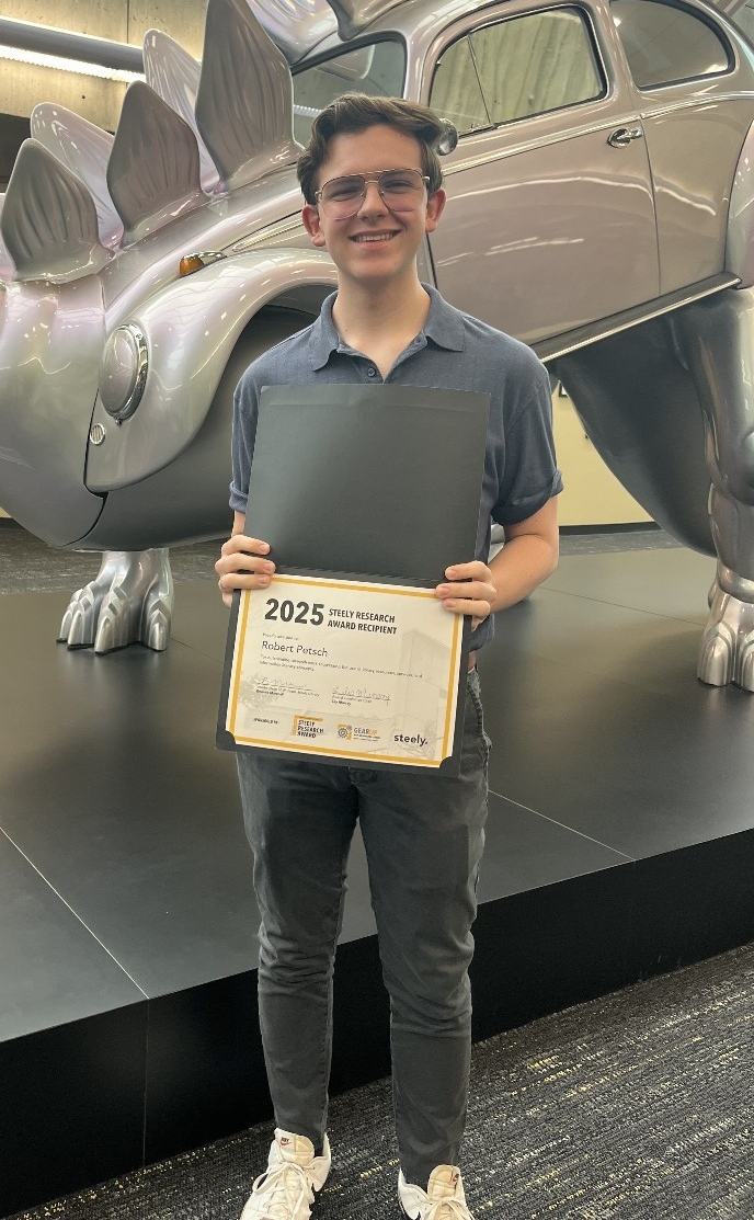 Robert Petsch holding his certificate