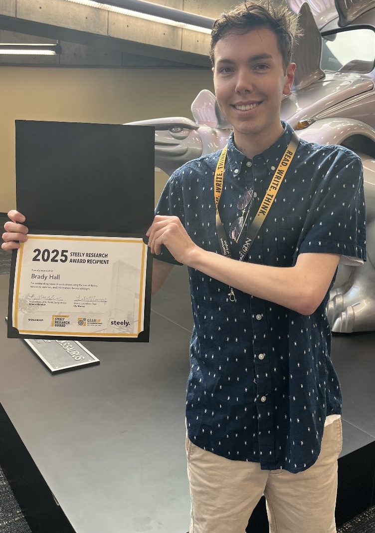 Brady Hall holding his certificate
