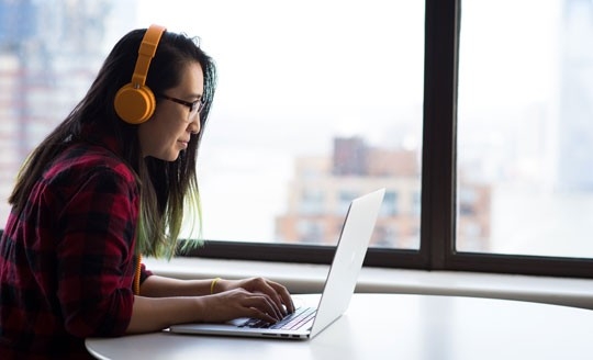Woman accessing digital records on laptop