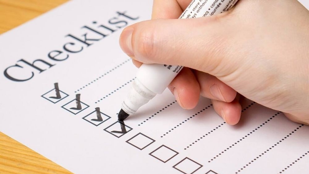 Hand ticking off checklist with a marker