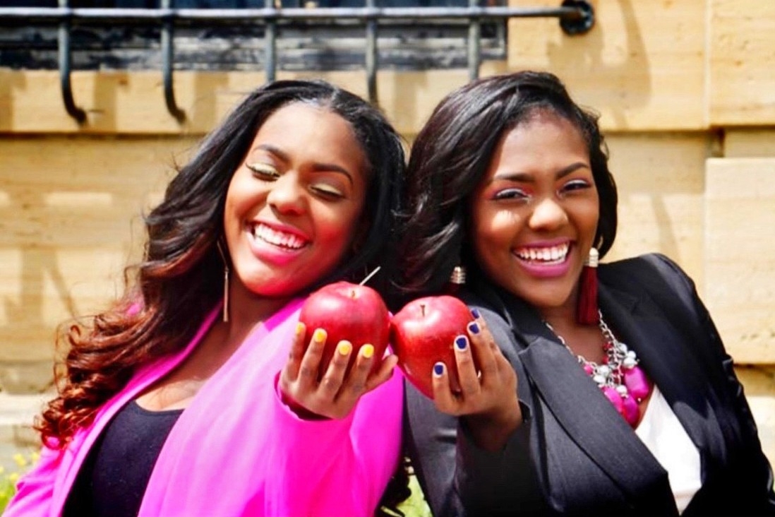 Mariah and Maya Manson, NKU alumnae, holding apples