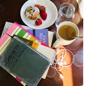 Breakfast and books on table