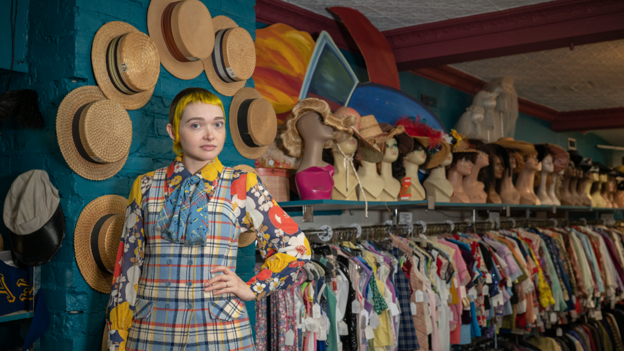 Ashley Beaufille Cook stands in front of store display