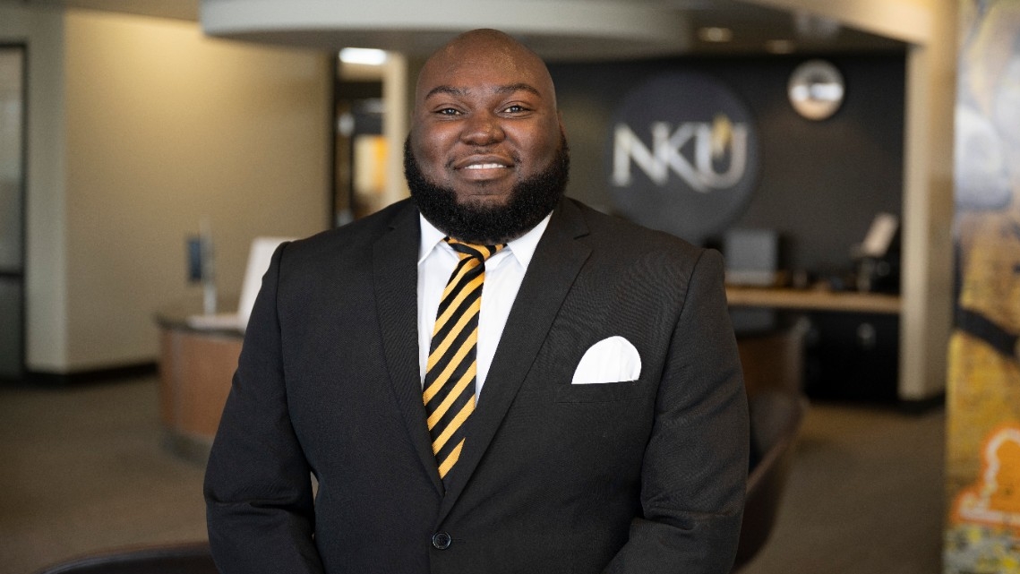 Javance Sinclair stands in front of office in Student Union.