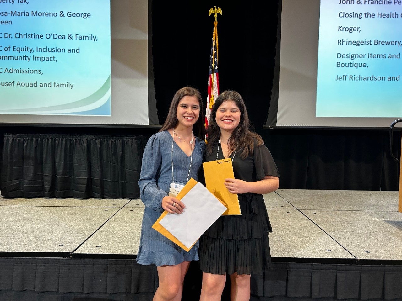  Maggie and Melissa stand in front of a stage 