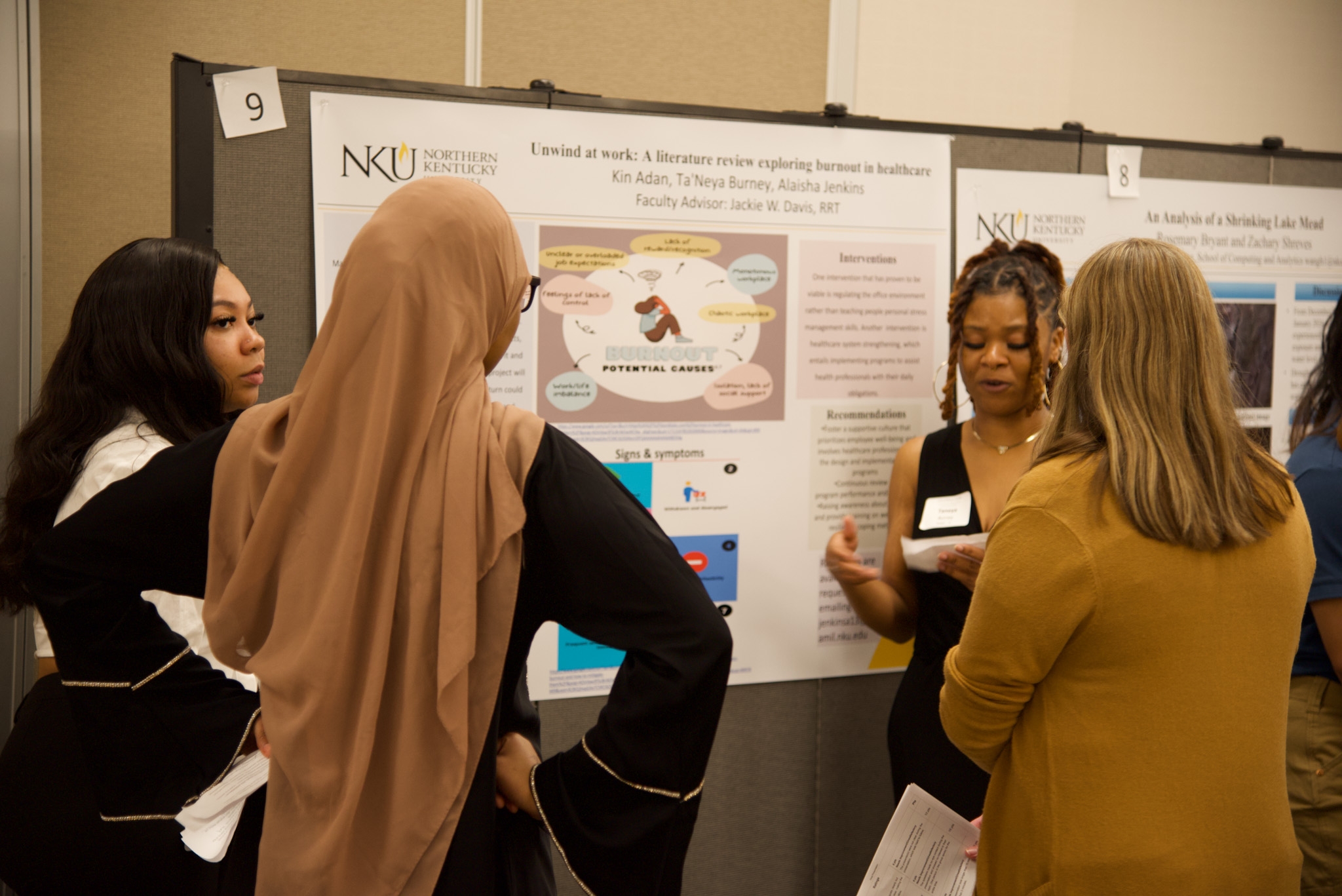 Students discuss their poster presentations