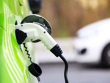 Conceptual image of EV charging of a vehicle with background blurred