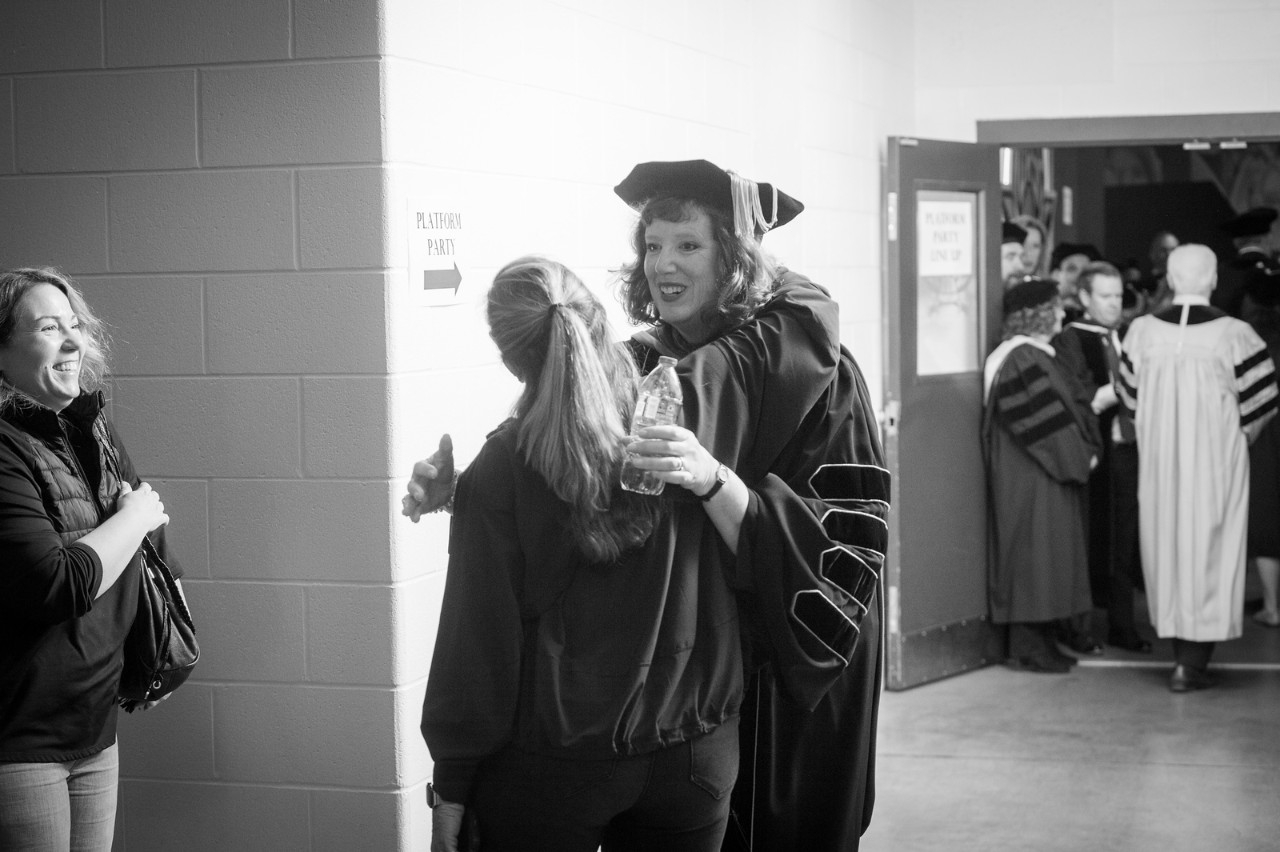 Cady Short Thompson hugging a graduate at Commencement