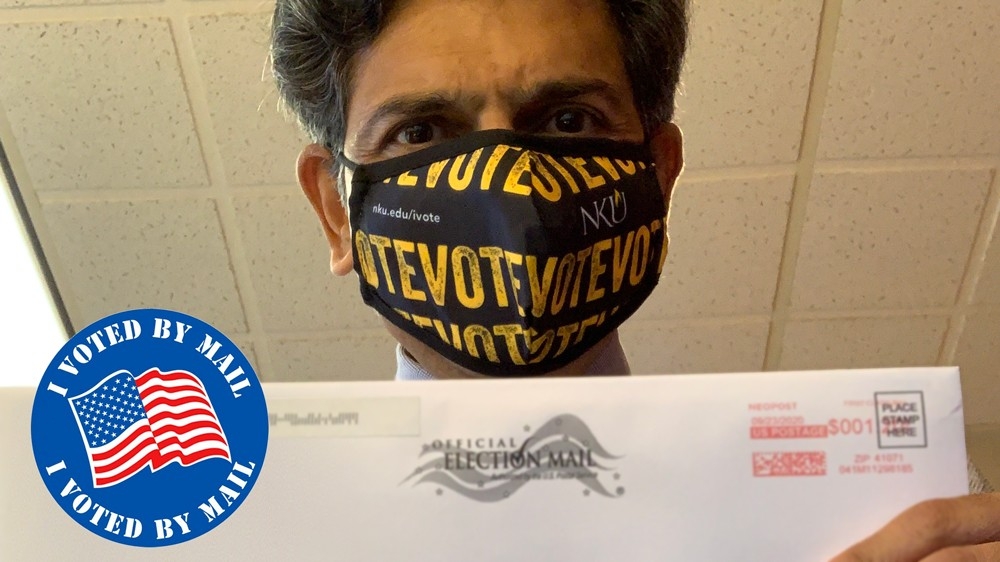 President Vaidya wearing iVote facial covering with his ballot envelope.