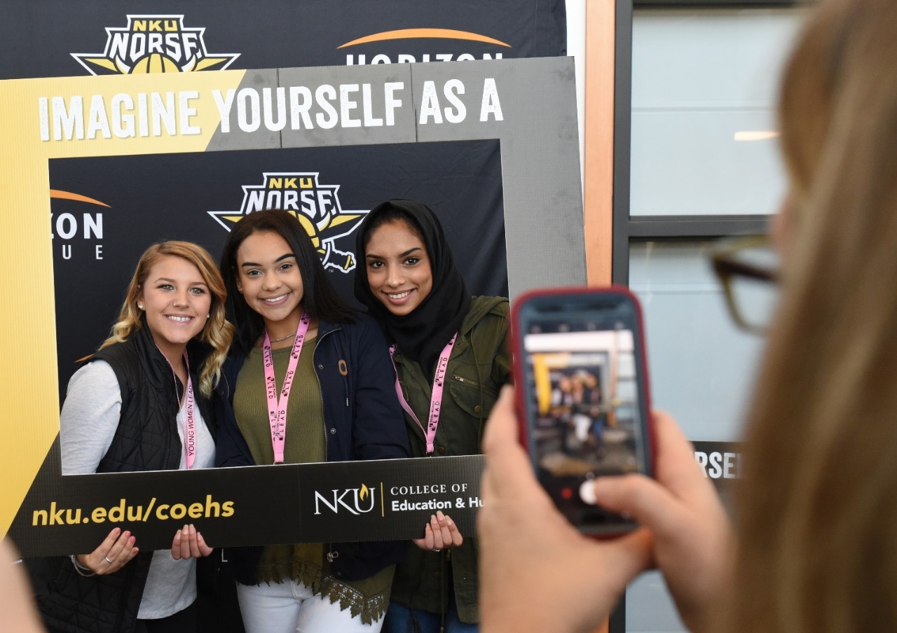 Three female students posing for a camera