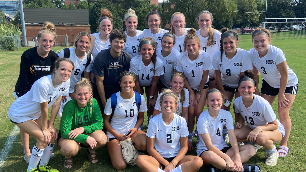 Group of female student soccer players posing