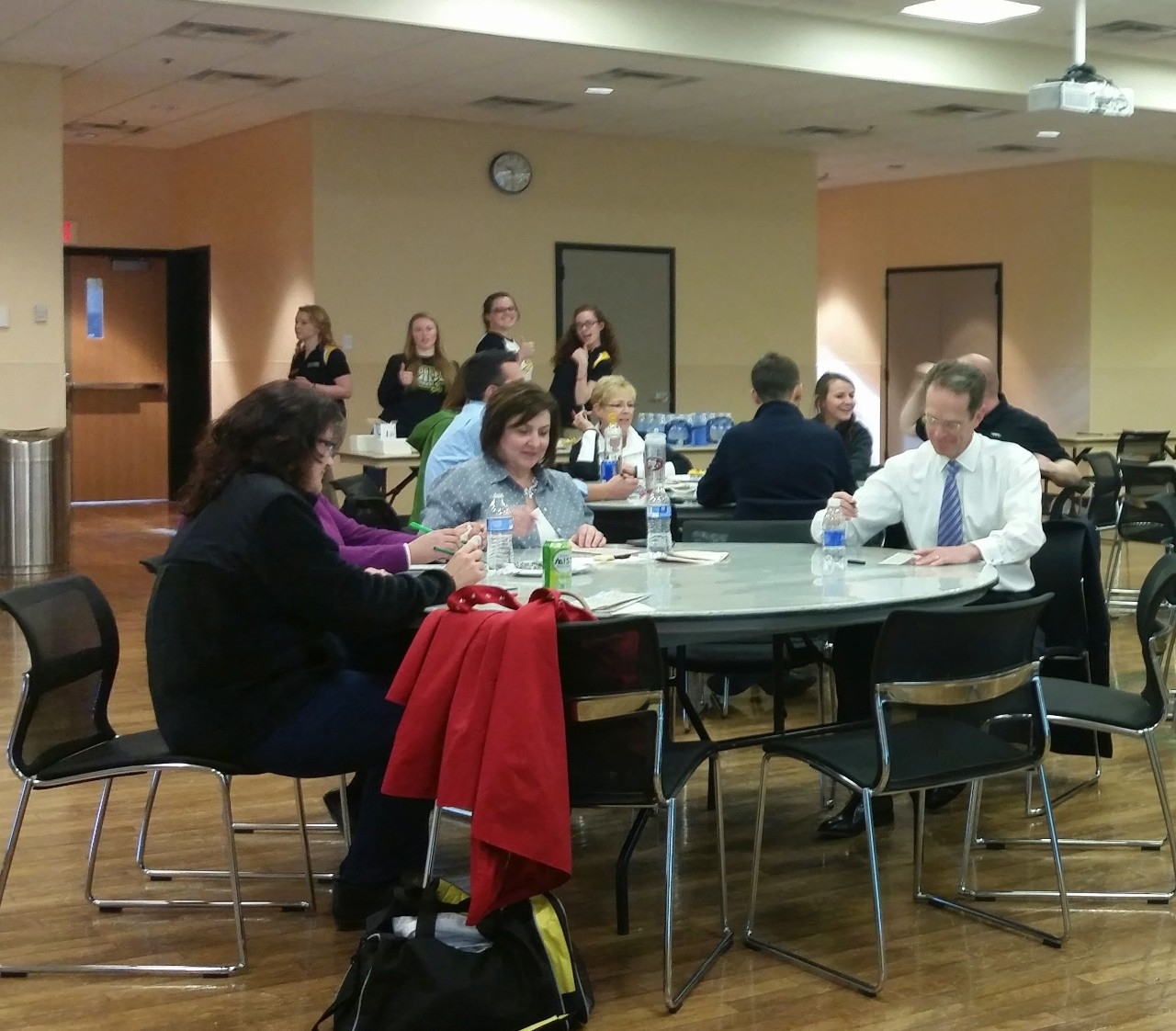 Faculty and staff sitting around a table playing bingo